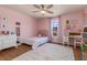 Pink themed bedroom with ceiling fan, rug, and desk at 2427 Carnation Ct, North Port, FL 34289