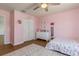 Pink themed bedroom with ceiling fan, rug, and dresser at 2427 Carnation Ct, North Port, FL 34289