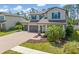 Lovely two-story home showcasing lush landscaping, a three-car garage, and a spacious driveway at 2427 Carnation Ct, North Port, FL 34289