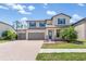 Charming two-story home with three-car garage and manicured lawn, perfect for Gathering living at 2427 Carnation Ct, North Port, FL 34289