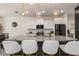 Modern kitchen features a large island with seating, granite countertops, and stainless steel appliances at 2427 Carnation Ct, North Port, FL 34289