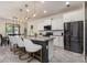 Modern kitchen with white cabinetry, granite countertops, stainless steel appliances, and a large center island at 2427 Carnation Ct, North Port, FL 34289