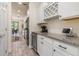 Bright kitchen with granite countertops, wine rack, and stainless steel refrigerator and wine cooler at 2427 Carnation Ct, North Port, FL 34289