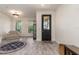 Inviting entryway with a stylish front door, comfortable seating area, and ample natural light at 2427 Carnation Ct, North Port, FL 34289