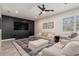 Stylish living room with a dark accent wall, modern ceiling fan, and neutral-toned furniture at 2427 Carnation Ct, North Port, FL 34289