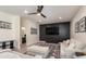 Well-lit living room features dark accent wall, recessed lights, and neutral colored couches at 2427 Carnation Ct, North Port, FL 34289