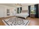 Serene main bedroom featuring a plush bed, hardwood floors, and a modern ensuite bathroom at 2427 Carnation Ct, North Port, FL 34289