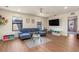 Spacious playroom with a comfortable blue sectional sofa, perfect for Gathering time at 2427 Carnation Ct, North Port, FL 34289