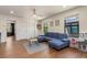 Bright playroom with a blue sectional sofa, hardwood floors, and plenty of natural light at 2427 Carnation Ct, North Port, FL 34289