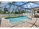 Beautiful backyard swimming pool surrounded by brick pavers and a screened enclosure at 2427 Carnation Ct, North Port, FL 34289