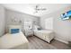 Well-lit bedroom showcasing two twin beds, neutral decor, and ceiling fan at 2621 Larkspur Dr, Punta Gorda, FL 33950