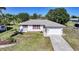 Aerial view of charming single-story home featuring well-maintained landscaping, attached garage, and long driveway at 2621 Larkspur Dr, Punta Gorda, FL 33950