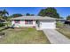 Charming single-story home with a well-manicured lawn and a convenient attached two-car garage at 2621 Larkspur Dr, Punta Gorda, FL 33950