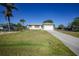Charming single-story home featuring well-maintained landscaping, attached garage, and long driveway at 2621 Larkspur Dr, Punta Gorda, FL 33950