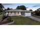Charming single-story home featuring well-maintained landscaping, attached garage, and inviting entrance at 2621 Larkspur Dr, Punta Gorda, FL 33950