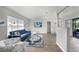 Spacious living area with modern decor, laminate flooring, and seamless flow into the dining area at 2621 Larkspur Dr, Punta Gorda, FL 33950