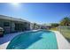 Backyard showcasing a private in-ground swimming pool, screened lanai, and partially fenced yard at 2621 Larkspur Dr, Punta Gorda, FL 33950