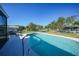 This backyard features an in-ground swimming pool, chain-link fence, and surrounding green space at 2621 Larkspur Dr, Punta Gorda, FL 33950