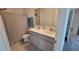 Bathroom with dual sinks, a walk-in shower, and neutral-colored walls for a spa-like experience at 26456 View Dr, Punta Gorda, FL 33983