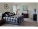 Cozy bedroom with carpet, neutral walls, and a large bed with bedside tables and lamps at 26456 View Dr, Punta Gorda, FL 33983