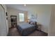 Serene bedroom with neutral tones, a bookshelf, and a bedside table for a tranquil retreat at 26456 View Dr, Punta Gorda, FL 33983