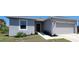Charming home with a two-car garage, walkway to front door, window and beautiful landscaping at 26456 View Dr, Punta Gorda, FL 33983