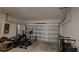 Spacious garage with an open door and ample storage and various sports equipment at 26456 View Dr, Punta Gorda, FL 33983