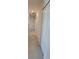 Hallway with neutral tile flooring and white walls; features a large closet at 26456 View Dr, Punta Gorda, FL 33983