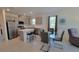 Modern kitchen with stainless steel appliances, an island with bar stools, and an adjacent dining area at 26456 View Dr, Punta Gorda, FL 33983
