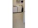 Well-lit laundry room with modern white washer and dryer on tile floor at 26456 View Dr, Punta Gorda, FL 33983