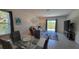 Inviting living area with a comfortable seating arrangement, large TV, and a sliding glass door to the outdoor space at 26456 View Dr, Punta Gorda, FL 33983