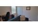 Cozy living room with couch, desk, and chair, perfect for work or relaxation at 26456 View Dr, Punta Gorda, FL 33983