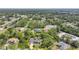 An aerial view showcases the property surrounded by lush trees, offering a private and serene ambiance at 2666 Barry Rd, North Port, FL 34286