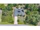 An aerial view highlights the property's well-maintained home, solar panels, long driveway, and lush surroundings at 2666 Barry Rd, North Port, FL 34286