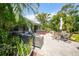 A beautiful outdoor patio with a hot tub, lounge area, and lush tropical landscaping creates a relaxing retreat at 2666 Barry Rd, North Port, FL 34286