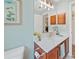 Bright bathroom featuring a granite vanity, framed mirror, and natural light at 2666 Barry Rd, North Port, FL 34286