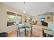 Bright breakfast nook with a glass table, views of the screened lanai, and an open layout to the living area at 2666 Barry Rd, North Port, FL 34286