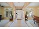Bright foyer with tiled flooring, high ceilings, decorative windows, and a classic white front door with patterned glass at 2666 Barry Rd, North Port, FL 34286