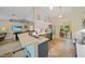 Open kitchen featuring a breakfast bar with seating, modern appliances, and sleek white countertops at 2666 Barry Rd, North Port, FL 34286