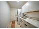 Laundry room with white cabinets, countertop, and washer/dryer at 2666 Barry Rd, North Port, FL 34286