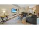 Spacious living room with a comfortable sectional sofa, mounted TV, and stylish decor, perfect for relaxing at 2666 Barry Rd, North Port, FL 34286