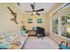 Cozy home office featuring a comfortable sofa, large windows offering natural light, and a functional workspace at 2666 Barry Rd, North Port, FL 34286