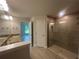 Main bathroom featuring double sinks with granite counters, tile floors and a walk-in shower with glass doors at 337 Rosario St, Punta Gorda, FL 33983