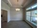 Bright dining room with tile floors, and a chandelier adjacent to a set of windows at 337 Rosario St, Punta Gorda, FL 33983