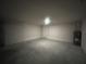 A spacious one car garage featuring light grey walls and a concrete floor at 337 Rosario St, Punta Gorda, FL 33983