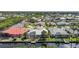 Aerial view of waterfront homes in a neighborhood on a canal with mature trees and tropical landscaping at 3513 Dileuca St, Punta Gorda, FL 33950
