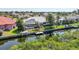 Enjoy waterfront living with a screened lanai, boat dock, and lush greenery in this picturesque backyard at 3513 Dileuca St, Punta Gorda, FL 33950
