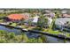 The home features a screened lanai, boat dock, and waterfront canal with tropical foliage at 3513 Dileuca St, Punta Gorda, FL 33950