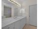 Bright bathroom features a large mirror and double vanity with lots of storage at 3513 Dileuca St, Punta Gorda, FL 33950