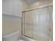 Tiled shower and bathtub combination with sliding glass doors at 3513 Dileuca St, Punta Gorda, FL 33950